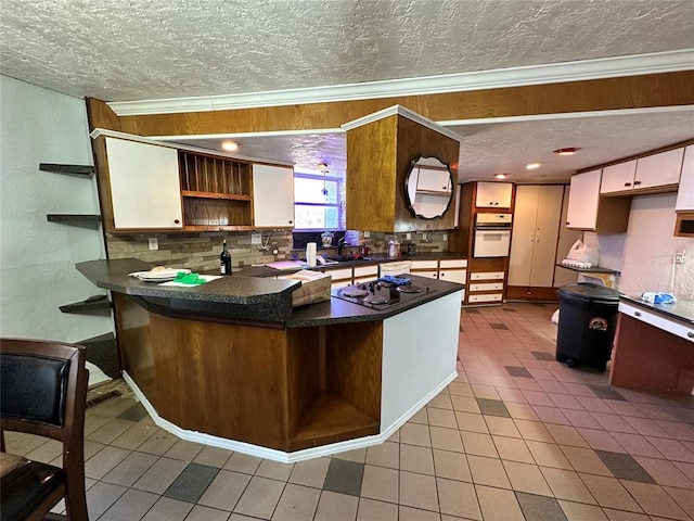 kitchen featuring black gas cooktop, oven, a peninsula, and open shelves