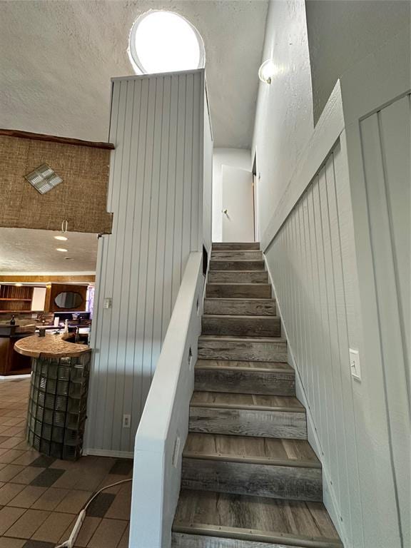 staircase featuring tile patterned flooring