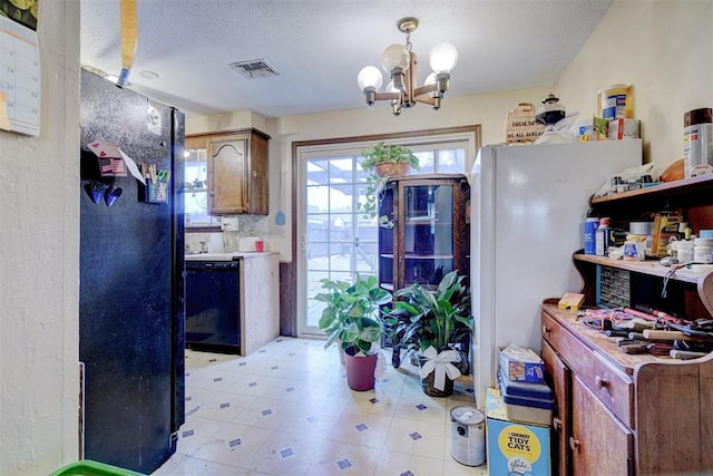 kitchen featuring a textured ceiling, visible vents, black dishwasher, light countertops, and pendant lighting