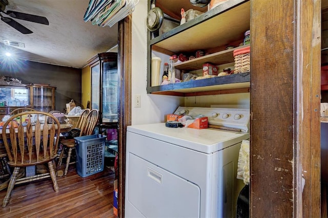 laundry area featuring a textured ceiling, laundry area, wood finished floors, visible vents, and washer / clothes dryer