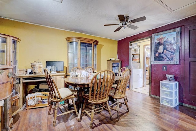 dining room featuring a textured ceiling, wood finished floors, and a ceiling fan