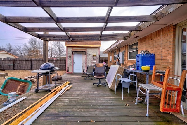 wooden deck with a fenced backyard and a pergola