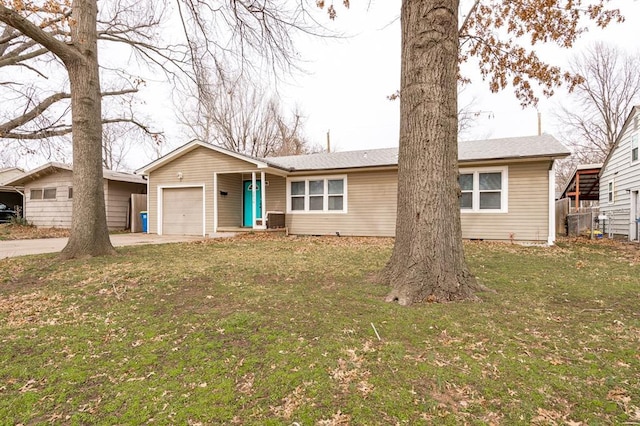 ranch-style house with a garage, a front yard, and driveway