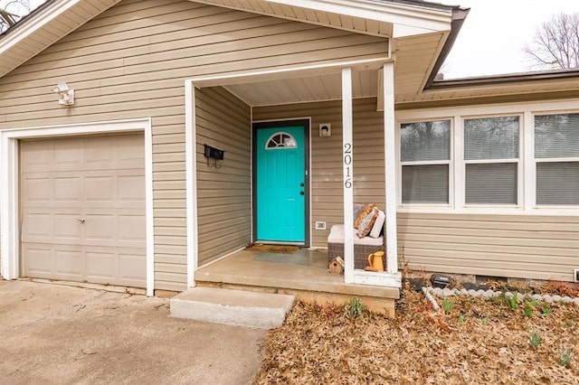 view of exterior entry with a garage