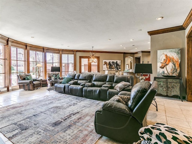 home theater featuring light tile patterned floors, ornamental molding, a textured ceiling, a notable chandelier, and recessed lighting