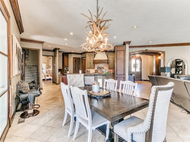 dining space featuring recessed lighting, arched walkways, a chandelier, and light tile patterned flooring