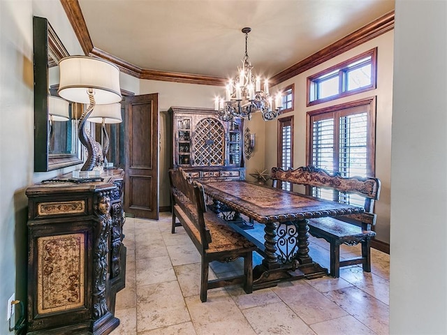 dining room featuring an inviting chandelier, stone tile floors, ornamental molding, and baseboards