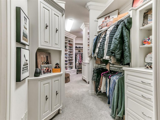 spacious closet with light carpet and decorative columns