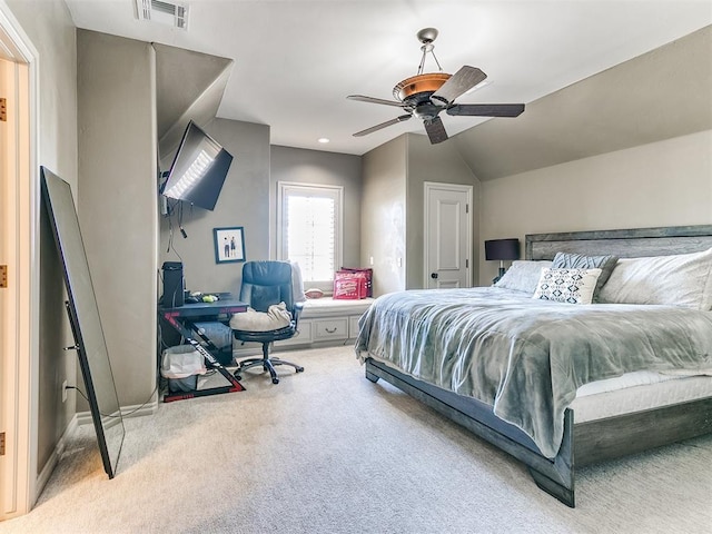 carpeted bedroom with ceiling fan, visible vents, and vaulted ceiling