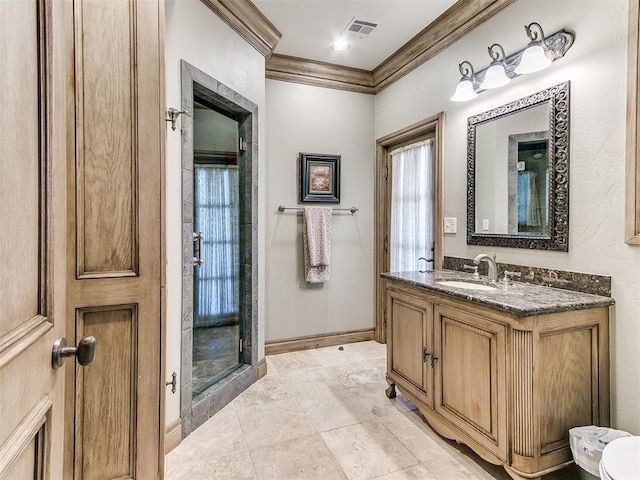 full bath with baseboards, vanity, visible vents, and crown molding