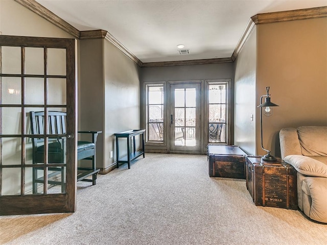 interior space featuring carpet floors, visible vents, crown molding, and baseboards