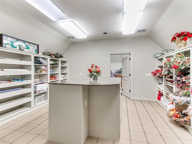 spacious closet with visible vents and vaulted ceiling