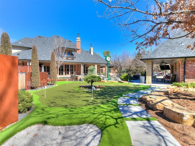 view of yard with ceiling fan, fence, and a patio