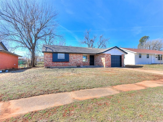 view of front of house featuring an attached garage, brick siding, driveway, and a front yard