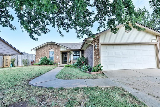 ranch-style house with an attached garage, a front lawn, concrete driveway, and brick siding