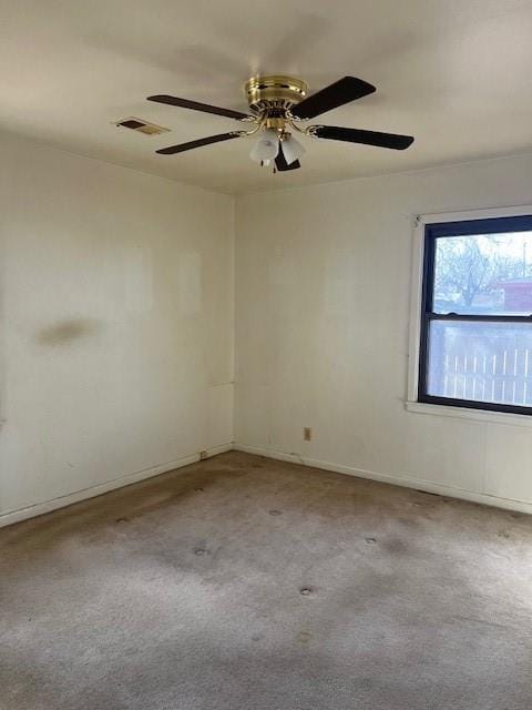 carpeted empty room with baseboards and visible vents