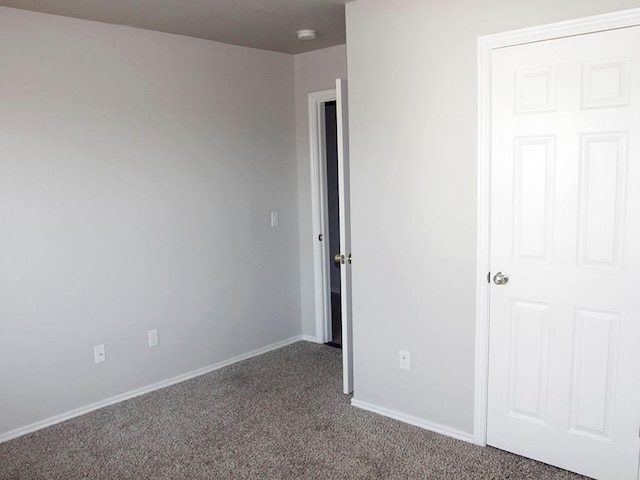 unfurnished bedroom with carpet floors and baseboards