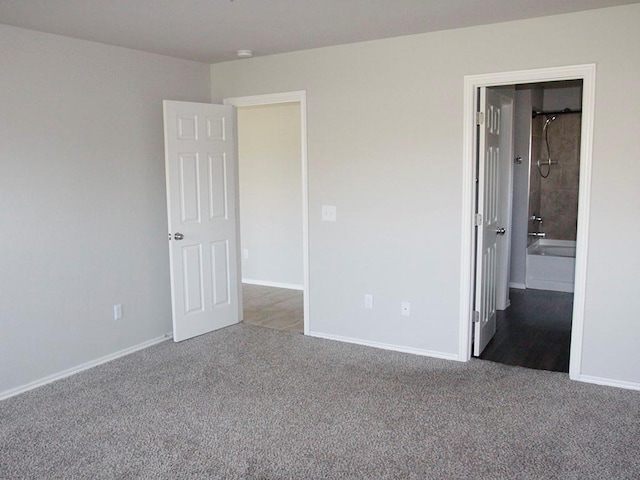 unfurnished bedroom featuring carpet and baseboards