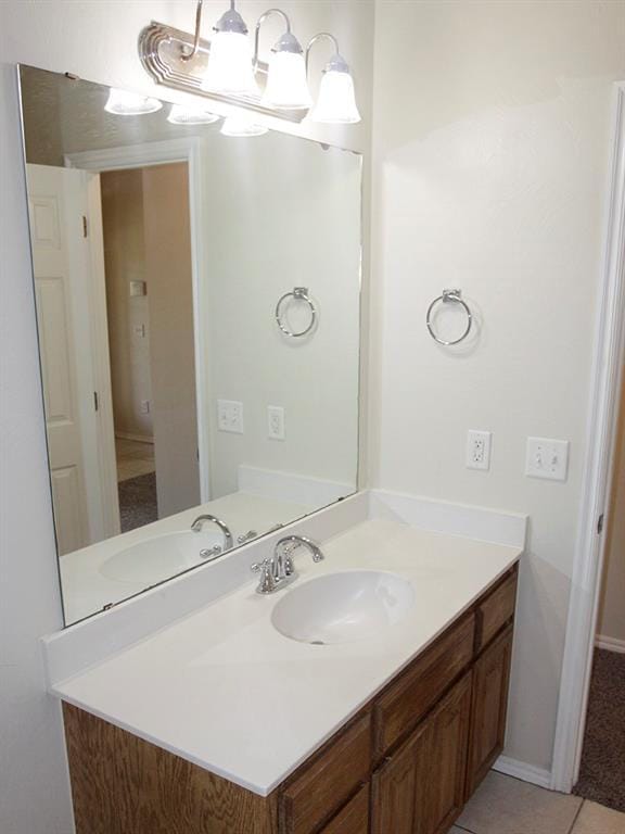 bathroom featuring tile patterned floors, baseboards, and vanity