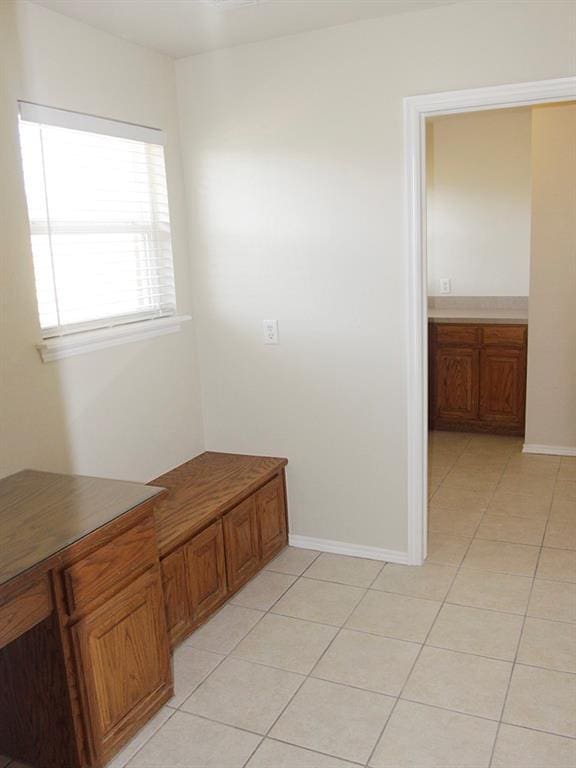 bathroom featuring tile patterned flooring and baseboards