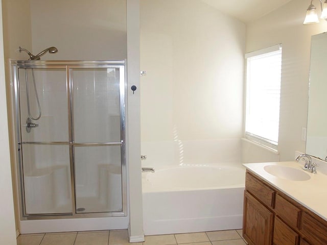 bathroom with a stall shower, tile patterned flooring, vanity, and a bath