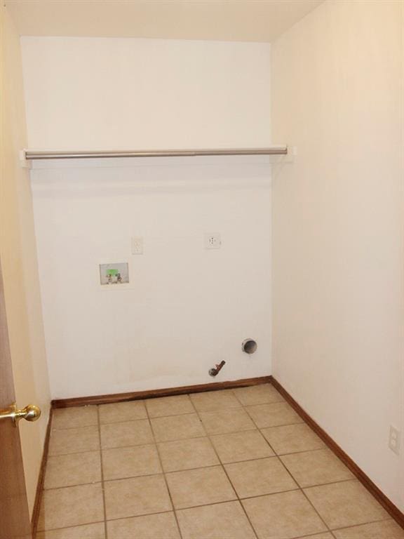 washroom with washer hookup, light tile patterned floors, gas dryer hookup, laundry area, and baseboards