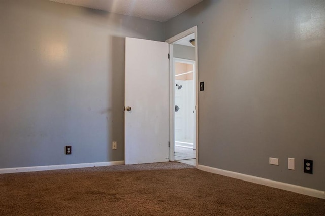 empty room with carpet and baseboards