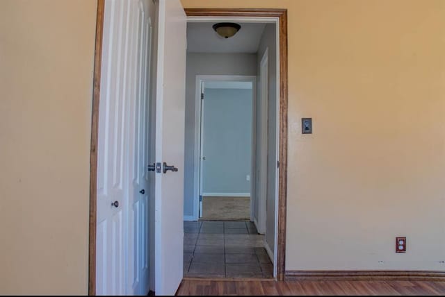 hall with tile patterned flooring and baseboards