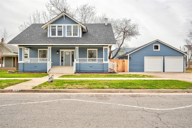 bungalow-style home featuring a garage, covered porch, fence, and a shingled roof