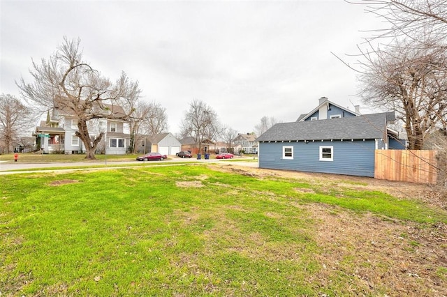 view of yard featuring a residential view and fence