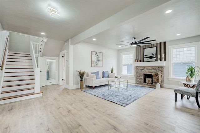 living room with a ceiling fan, stairway, wood finished floors, a fireplace, and recessed lighting