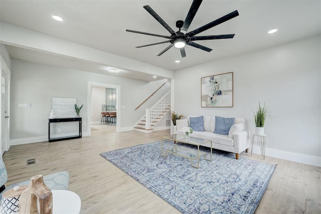 living area featuring stairway, wood finished floors, and recessed lighting