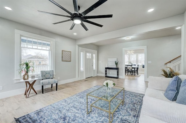 living area featuring baseboards, wood finished floors, and recessed lighting