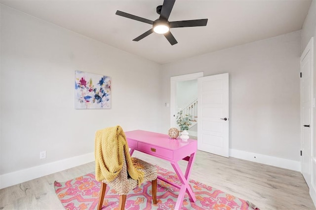 office area featuring a ceiling fan, baseboards, and wood finished floors