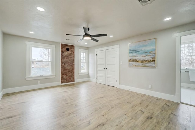 interior space featuring baseboards, visible vents, wood finished floors, and recessed lighting