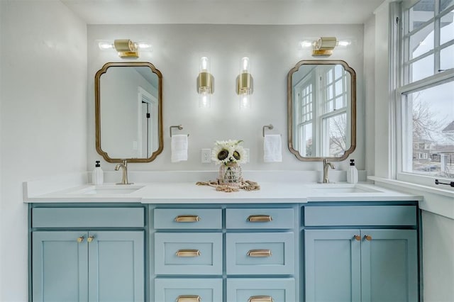 bathroom with a wealth of natural light, a sink, and double vanity