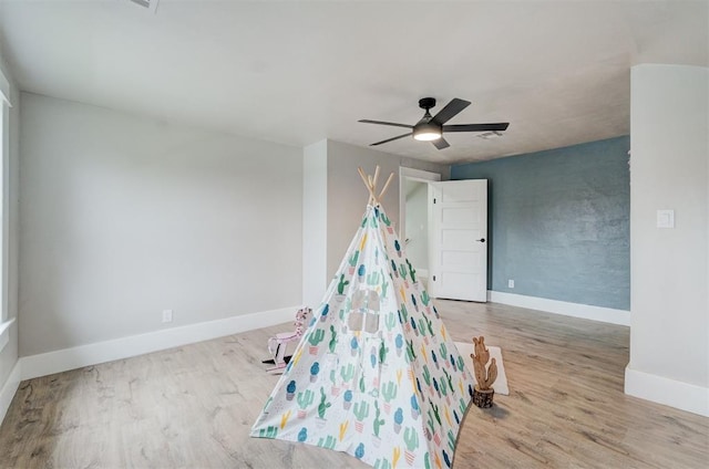 game room featuring ceiling fan, baseboards, and wood finished floors