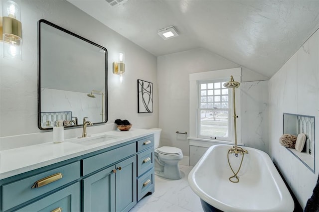 bathroom with a shower, lofted ceiling, marble finish floor, vanity, and a freestanding tub