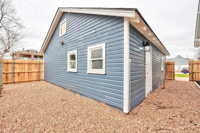 view of side of property featuring fence