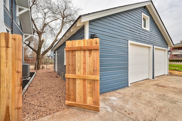 exterior space featuring central AC unit, an outdoor structure, and fence