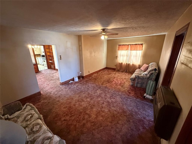 carpeted living room with ceiling fan, a textured ceiling, and baseboards