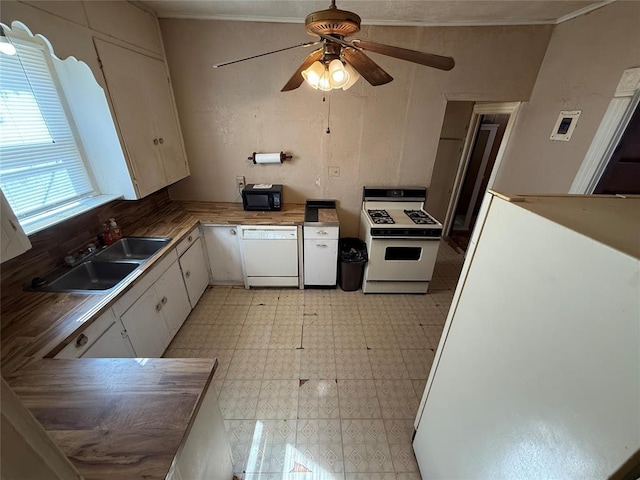 kitchen featuring light floors, white cabinetry, a sink, butcher block countertops, and white appliances