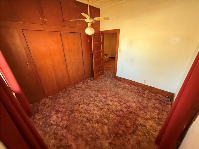 carpeted bedroom featuring a closet and baseboards