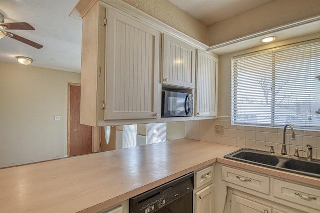 kitchen featuring tasteful backsplash, a ceiling fan, light countertops, black appliances, and a sink