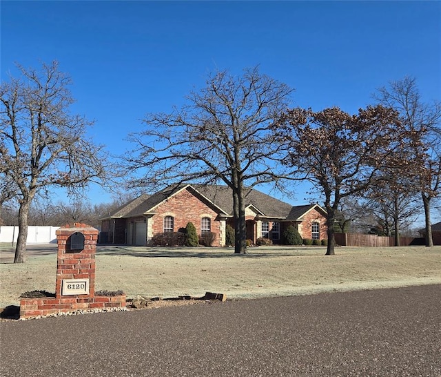 view of front of house with a garage and fence