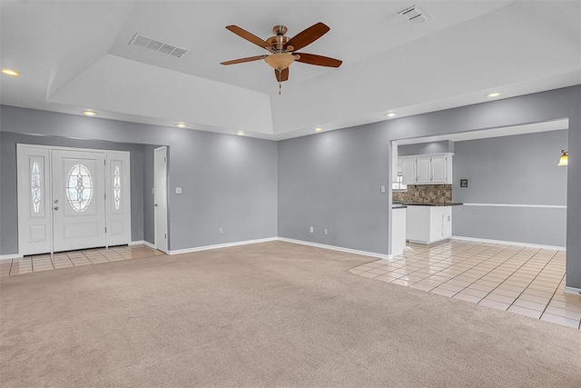 unfurnished living room with light carpet, visible vents, and light tile patterned flooring