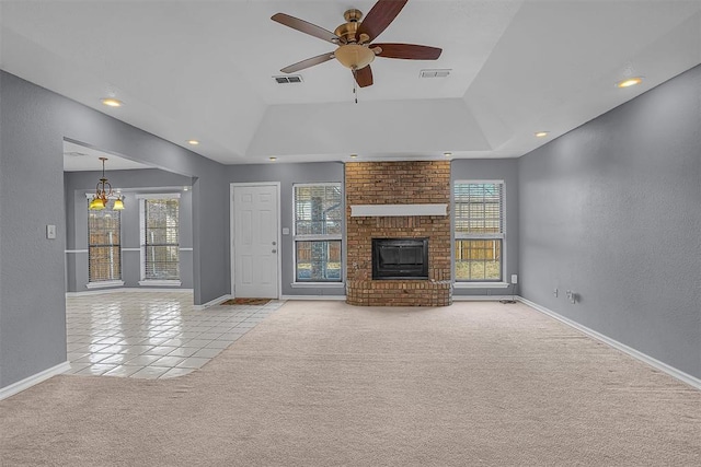 unfurnished living room with light carpet, baseboards, visible vents, a raised ceiling, and a brick fireplace