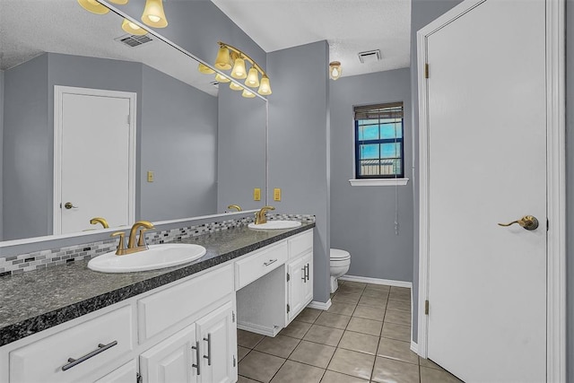 full bathroom with toilet, tile patterned flooring, visible vents, and a sink