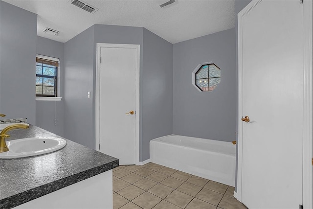 full bath featuring double vanity, visible vents, a sink, and tile patterned floors