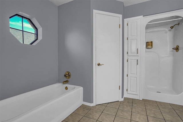 full bath with a textured ceiling and tile patterned floors